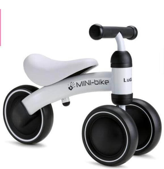 White baby balance bike with leather seat, carbon steel frame, and EVA wheels for comfortable riding and skill development.