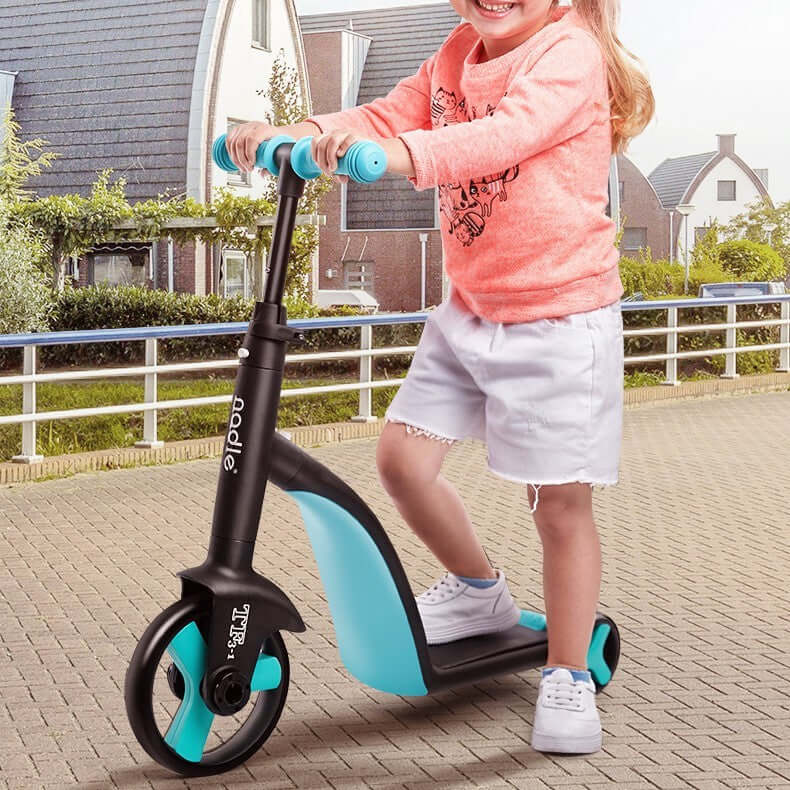 Child riding a blue and black balance scooter with three wheels on a paved path in a suburban neighborhood.